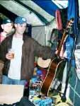 Paddy Kirkman of Molly Brown checks out a rather nice looking old Gibson acoustic on the Peter Norris Music Stand